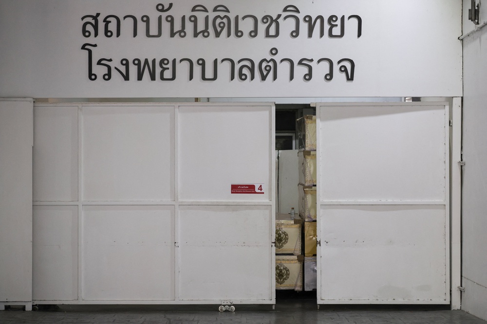 Coffins sit behind a door at the Police Hospital morgue following a deadly fire at a pub in Bangkok, Thailand (Reuters)