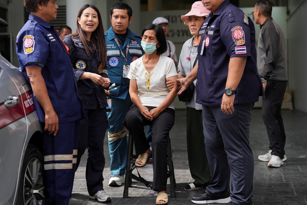A relative reacts after identifying a body following a deadly fire at a pub in Bangkok, Thailand, on 13 July 2026 (Reuters)