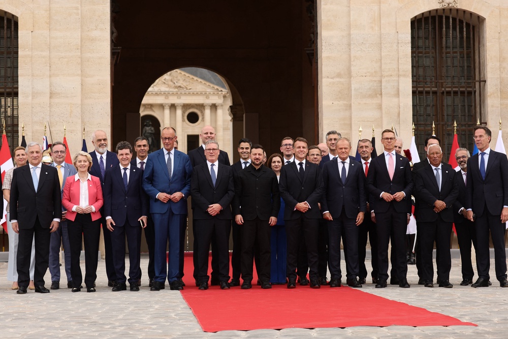 French President Emmanuel Macron (C-L) and Ukrainian President Volodymyr Zelensky (C) pose for a family picture with heads of states and governments before a summit of the Coalition of the Willing to support Ukraine at the Hotel des Invalides in Paris on July 13, 2026. (AFP/Getty)