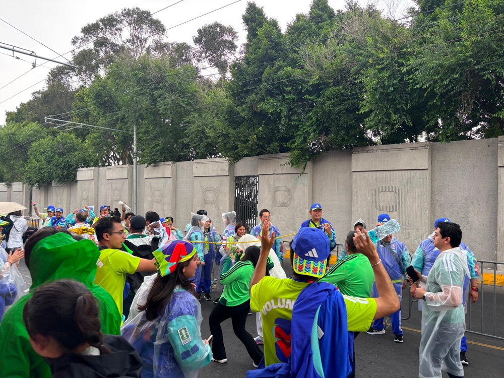 World Cup volunteers form a 'Limbo' dance scene for passers-by in Mexico City (Kieran Jackson/The Independent)