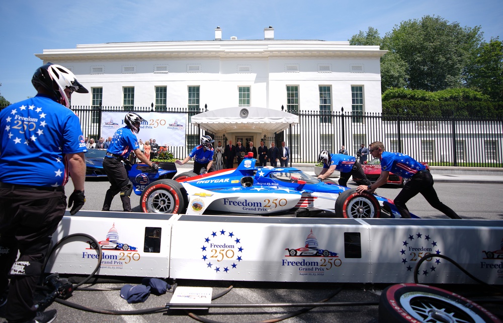 Trump was all smiles when a Freedom 250 race car pulled up to the White House during the event, and a crew jumped into action to perform a lightning-fast pit stop (Getty)