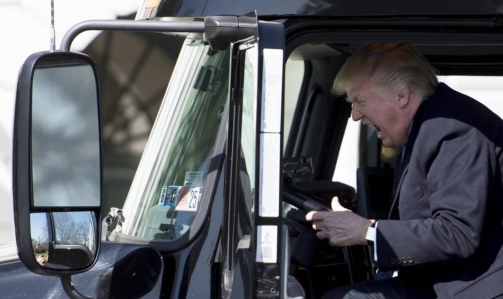 Trump reacts excitedly while sitting in a truck at the White House in 2017 (AFP/Getty)