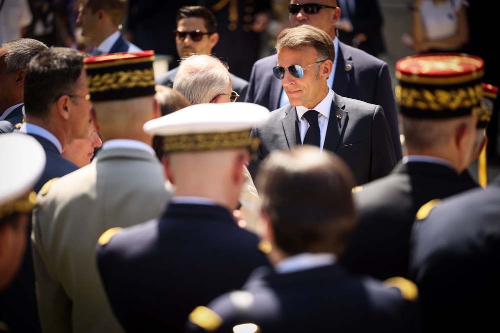 French President Emmanuel Macron greets senior military officers after his traditional address to the armed forces on the eve of the Bastille Day parade. (AP Photo/Thomas Padilla, Pool)