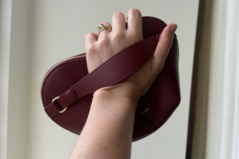 The pouch is held like a handbag (Alessia Armenise/The Independent)