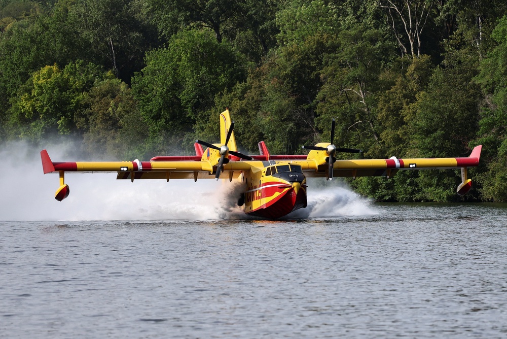 A firefighting Canadair aircraft skims the surface of the Seine River while collecting water in Ivry-sur-Seine, to assist efforts against a wildfire in the Fontainebleau forest during a heatwave affecting large parts of the country, near Paris, France, July 14, 2026. (Reuters)