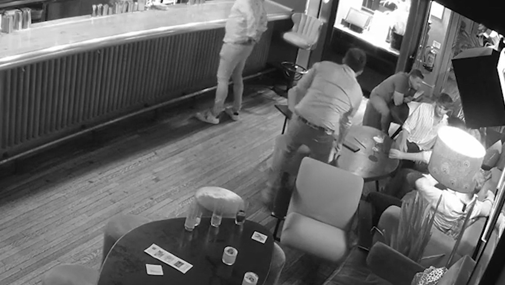 Handout screengrab from CCTV footage issued by Crown Prosecution Service of Patrick Spencer (centre, standing back to camera) in the Groucho Club, London, on 12 August 2023 (Crown Prosecution Service)