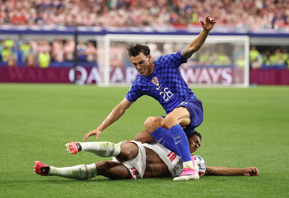 Bellingham slides through Croatia’s Petar Musa (Getty)