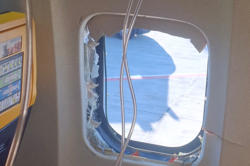 The window was damaged during the flight (Reuters)