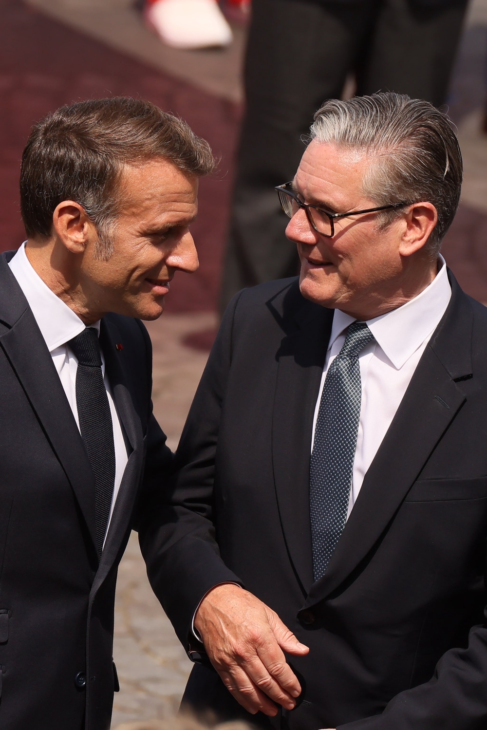French President Emmanuel Macron speaks with Sir Keir Starmer after the Bastille Day military parade (Thomas Padilla/AP) (AP)