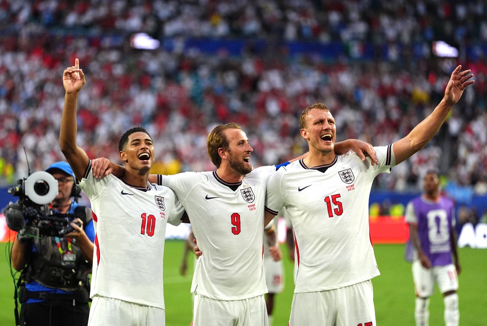 England’s Jude Bellingham, Harry Kane and Dan Burn sign Wonderwall after the quarter-final win against Norway (Martin Rickett/PA) (PA Wire)
