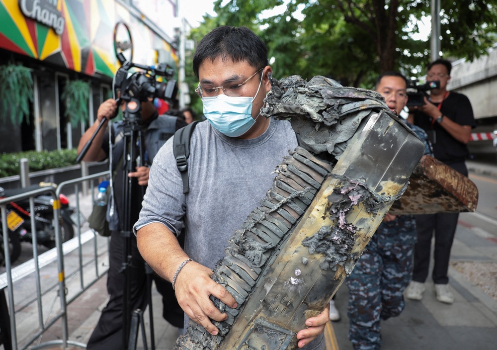 Brother of the victim, Phrutthiphong Phudmon who was a keyboard player of the band playing on the day of the deadly fire, carries Phudmon's music keyboard as he visits Rong Beer Na Lat Phrao bar (Reuters)