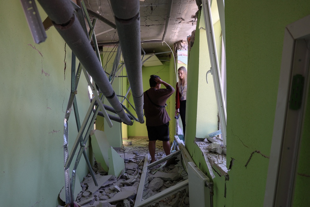 People stand in a hallway of a damaged residential building following a Russian strike in Odesa on July 15 (AFP/Getty)
