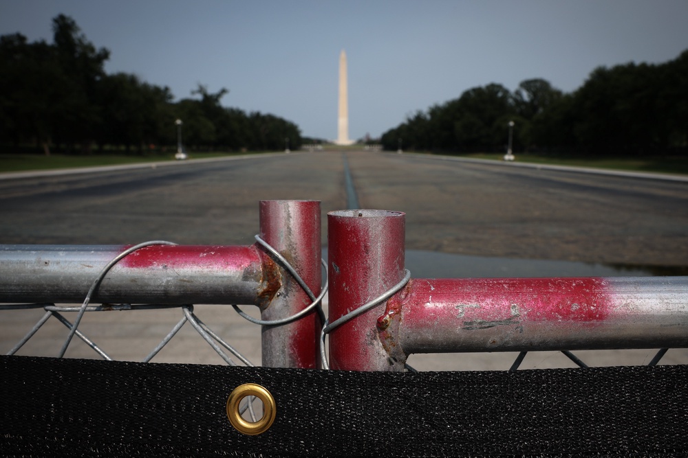 Several people who visited the Reflecting Pool Tuesday said they were unable to spot a 300-yard gash in the liner – though the administration has installed a chain-link fence which makes it difficult to view the entire pool (Getty)