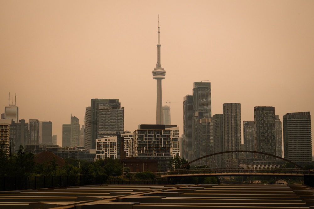 The sky in Toronto has turned yellow as smoke from over 100 wildfires invades the city (Laura Proctor/The Canadian Press)
