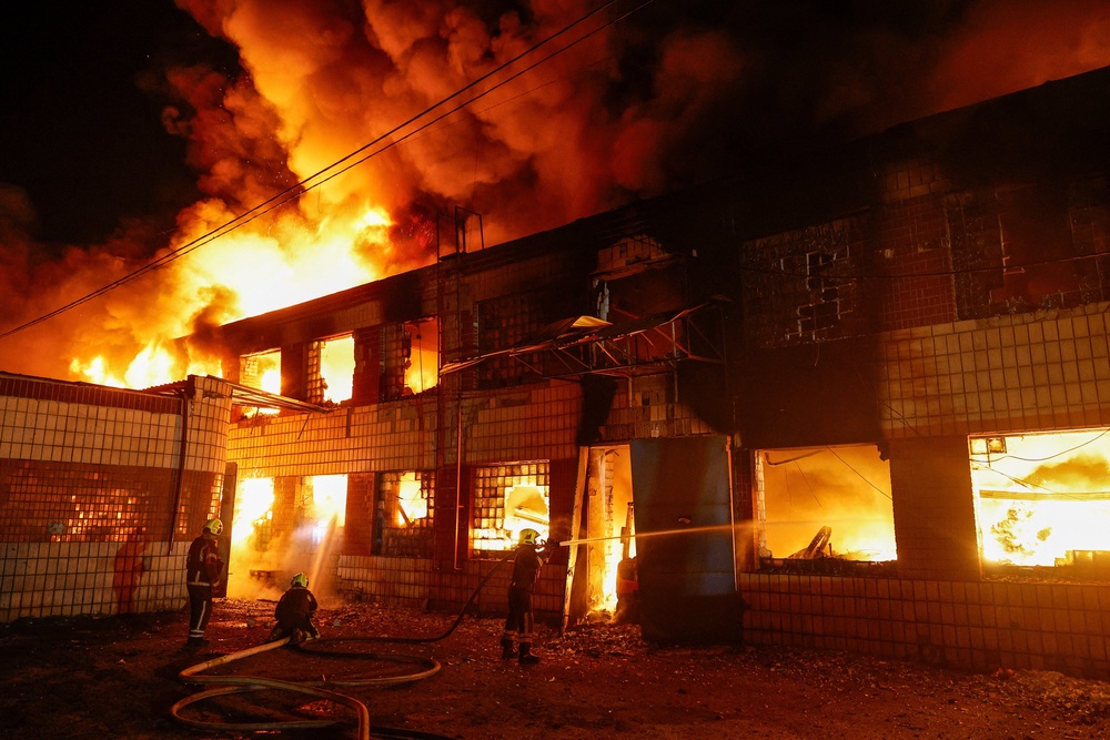 Firefighters work at a compound of a private enterprise damaged during Russian missile strikes, amid Russia's attack on Ukraine (Reuters)