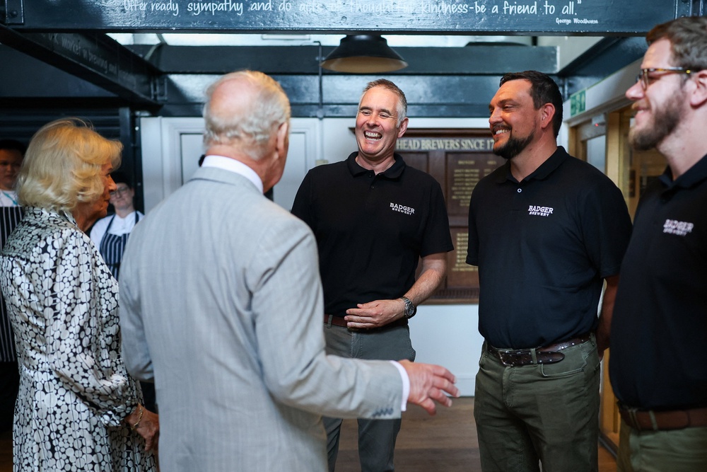 King Charles III and Queen Camilla talks with head brewer Toby Heasman and other employees (PA)