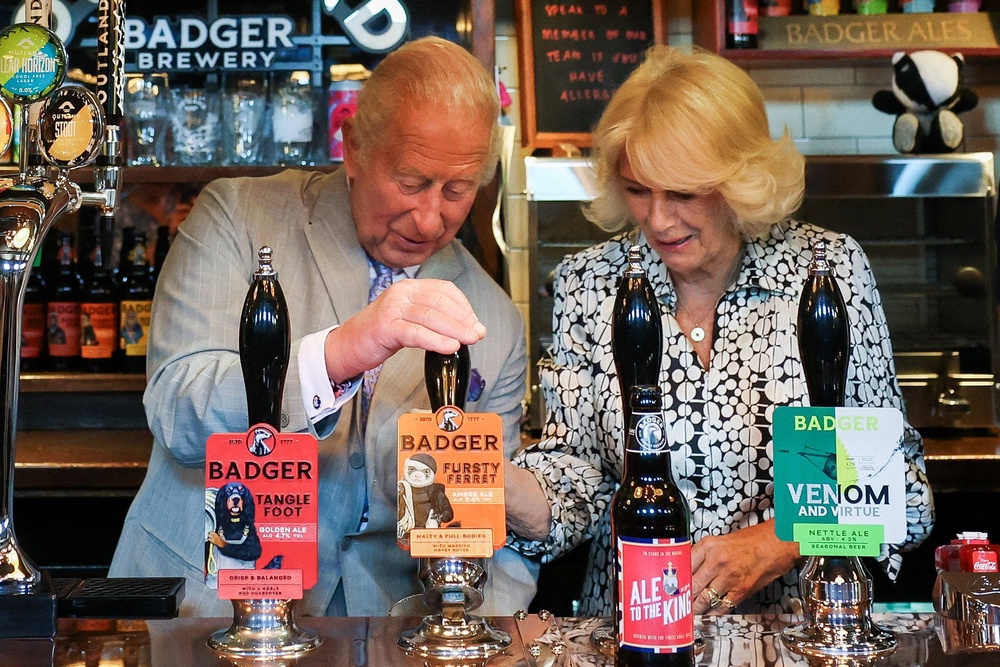 The King and Queen pour a pint of Fursty Ferret beer during a visit to the Hall and Woodhouse Badger Brewery in Blandford St Mary near Blandford Forum, Dorset (Isabel Infantes/PA) (PA Wire)