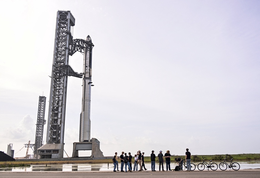 SpaceX employees gather near the Starship and Super Heavy v3 Booster at Starbase, Texas, on 16 July, 2026 (Reuters)