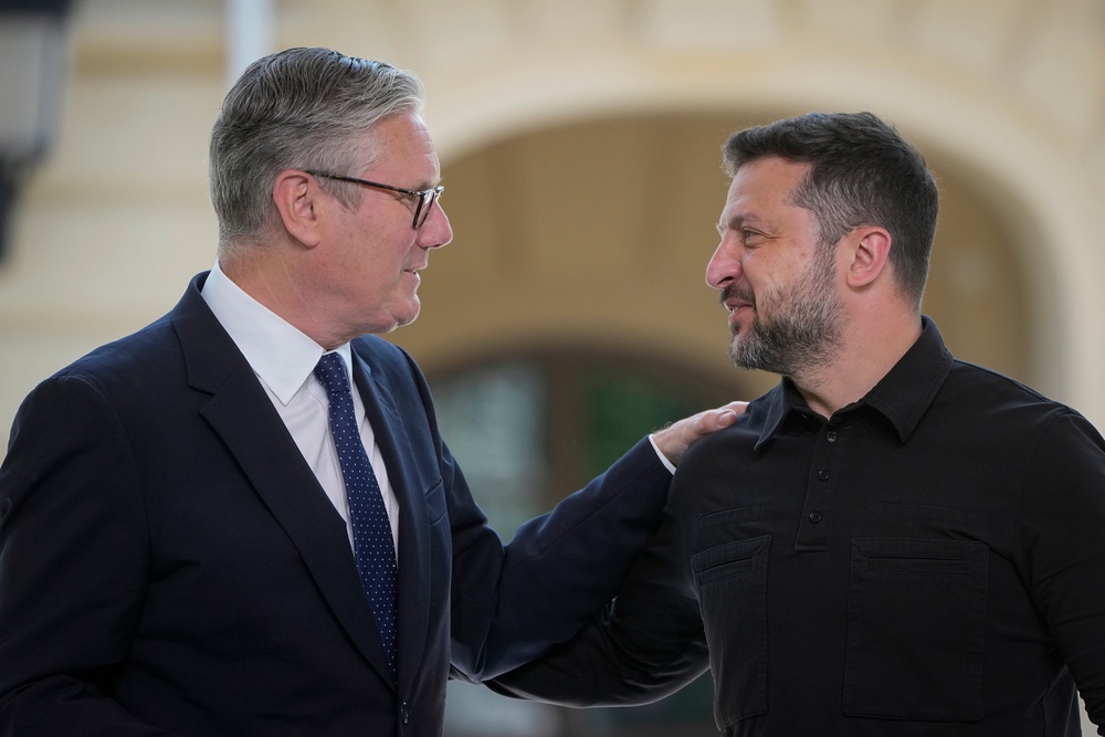 Sir Keir Starmer, left, and Ukraine's President Volodymyr Zelenskyy greet each other in Kyiv (AP)