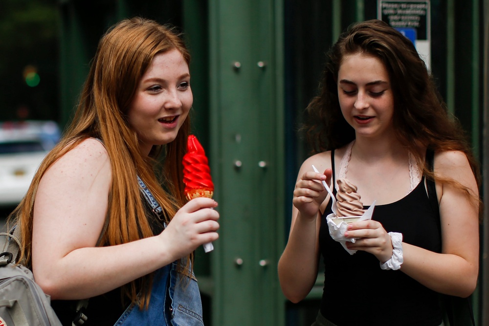 Women eat ice cream together in New York City’s Central Park in August 2018. Associating rising temperatures with positive feels could undermine the actual danger posed by heat (Getty)