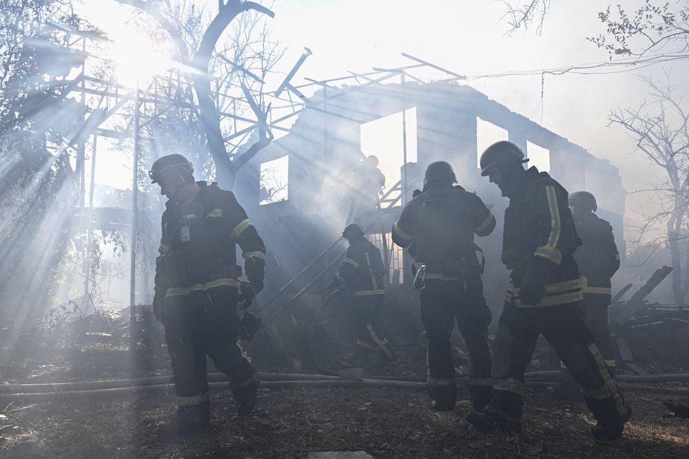 Firefighters work at the site of residential houses hit by a Russian air strike in Zaporizhzhia (Reuters)