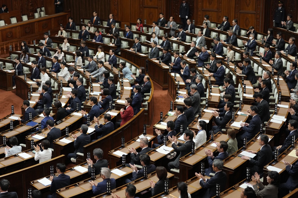 Members of Japan's Upper House react after passing a bill to revise the Imperial House Law (AP)