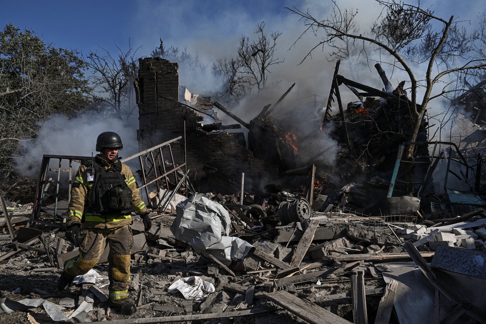 A firefighter works at the site of a residential area hit by a Russian air strike in Zaporizhzhia (Reuters)