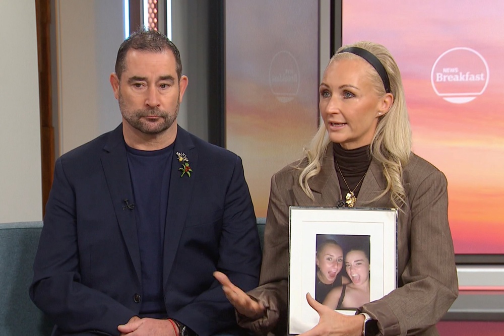 Michelle Jones, right, holds a photo of her daughter as she and her husband Mark Jones appear on a news programme in Melbourne (AP)