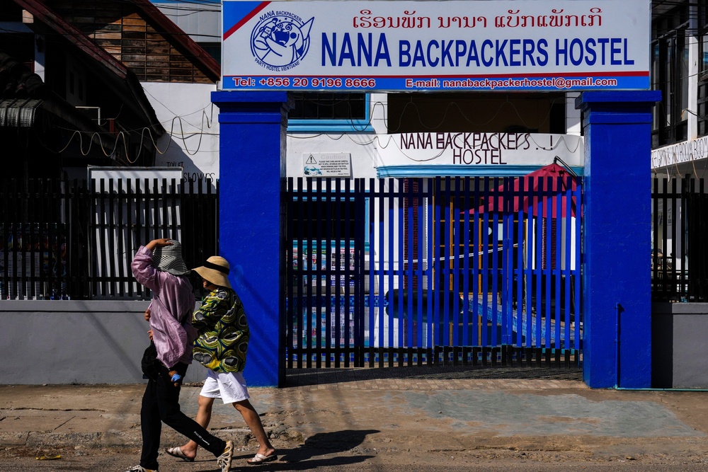 Tourists walk past the Nana Backpackers Hostel in Vang Vieng in Laos (AP)