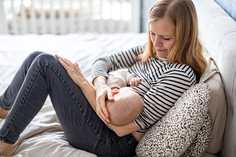 Parents say mothers are being forced to choose between breastfeeding their child and earning a living (Alamy/PA)