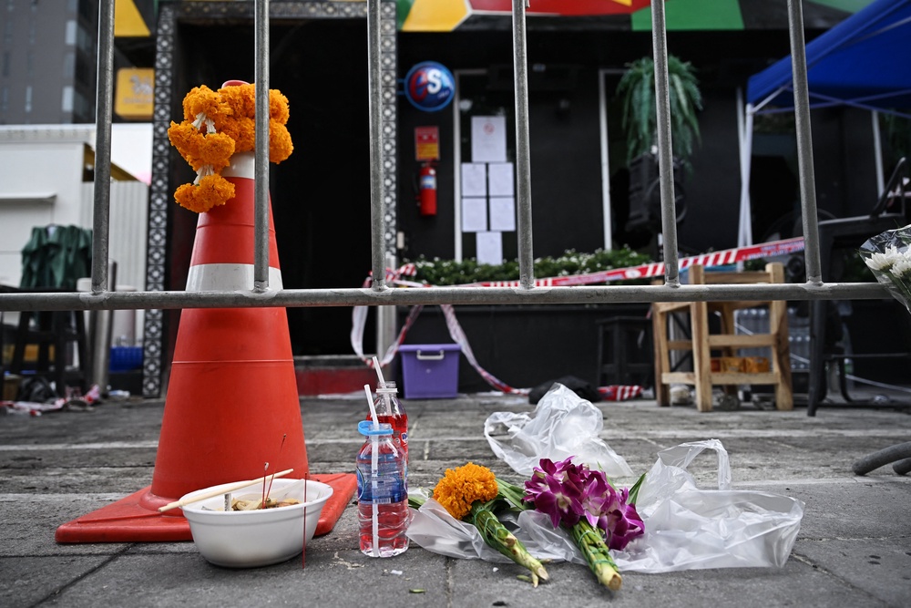 Flowers for victims in front of the Rong Beer Na Lat Phrao bar in Bangkok (AFP/Getty)