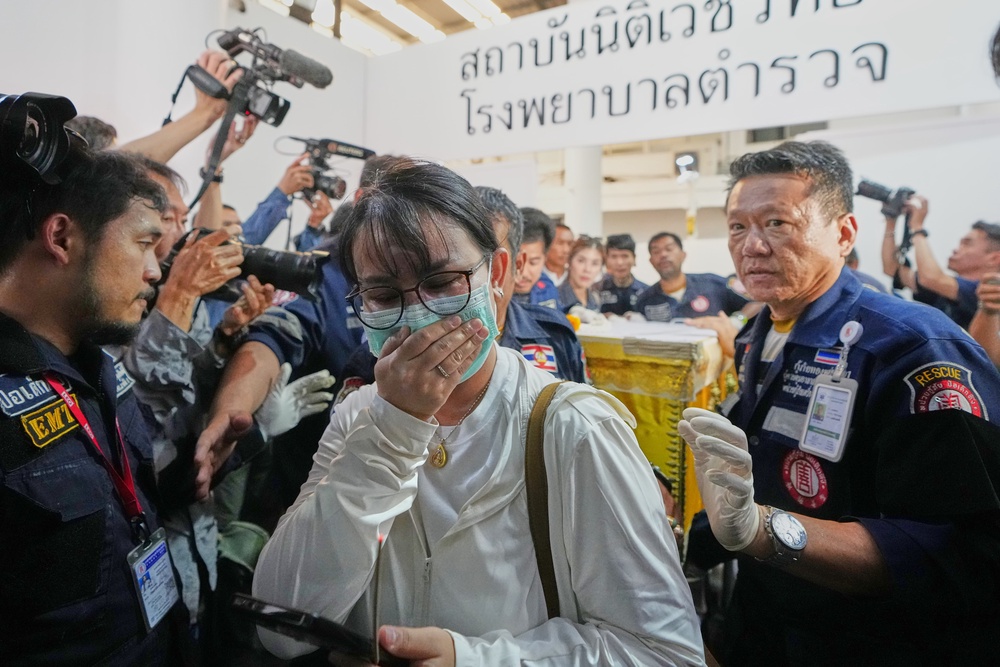 A coffin containing the body of a victim of the bar fire is transferred from a police hospital in Bangkok, Thailand (AP)