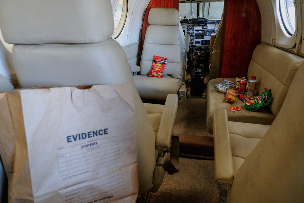 An evidence bag and Mexican snacks sit in the cabin of a Beechcraft King Air aircraft (Reuters)