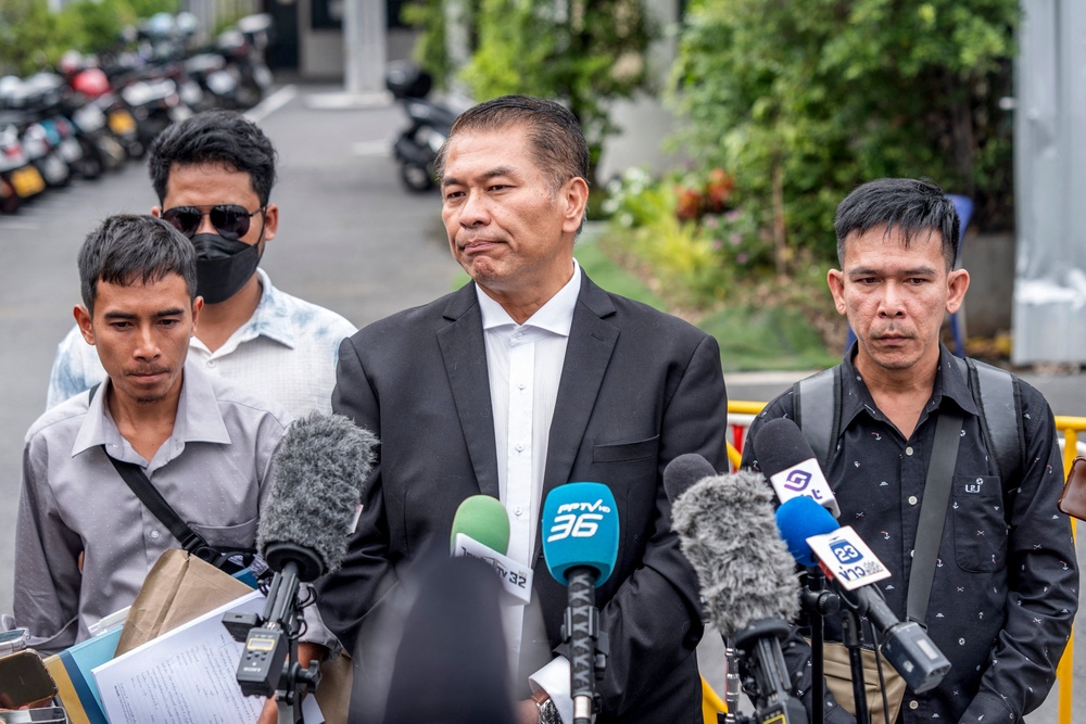 Thai lawyer Kunpat Singhathong speaks to the media with three former sailors from the Thai-flagged ship Mayuree Naree outside the Central Labour Court in Bangkok (AFP/Getty)