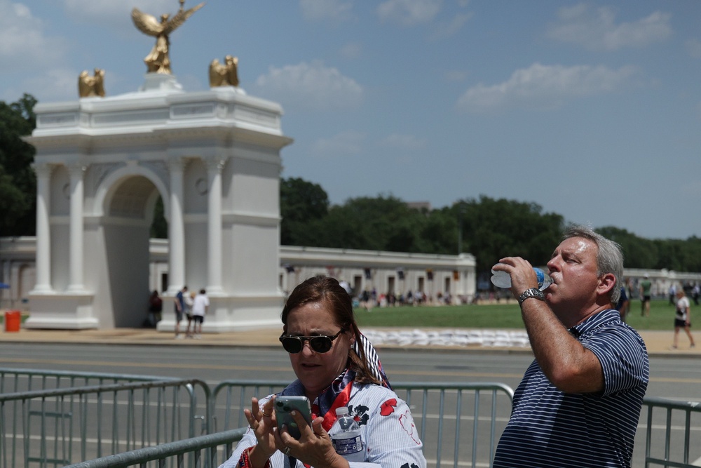A man drinks from a water bottle during the Great American State Fair on the National Mall in Washington, D.C., earlier this month. Rising temperatures are largely the consequence of burning oil and gas for energy (Getty Images)
