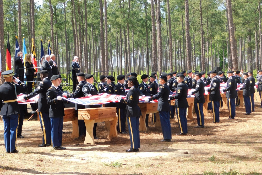 Military personnel fold flags for the remains of 12 Continental soldiers killed at the Battle of Camden, S.C., during a memorial ceremony on April 22, 2023 (Historic Camden Foundation/via AP)