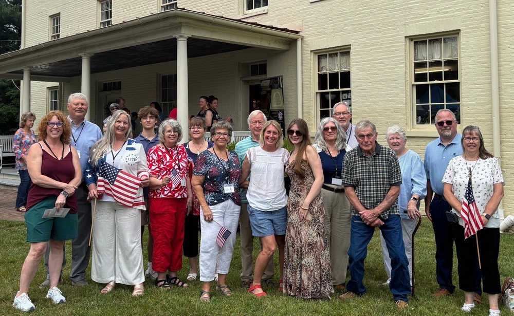 Relatives of Revolutionary War Pvt. John Pumphrey pose for a photo outside the 19th century Benson-Hammond House in Linthicum Heights, Md., on June 18, 2026 (FHD Forensics via AP)