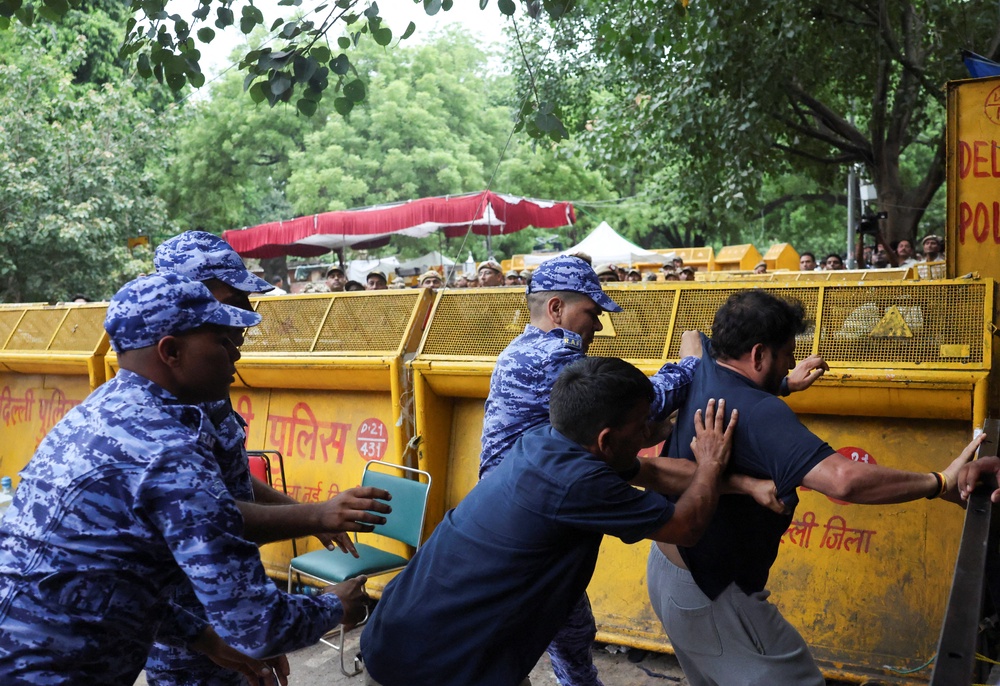 Members of the Indian security forces tussle with a supporter of Cockroach Janta Party (CJP) after authorities took Sonam Wangchuk, an Indian education reformer, who has been on hunger strike, to the hospital (Reuters)