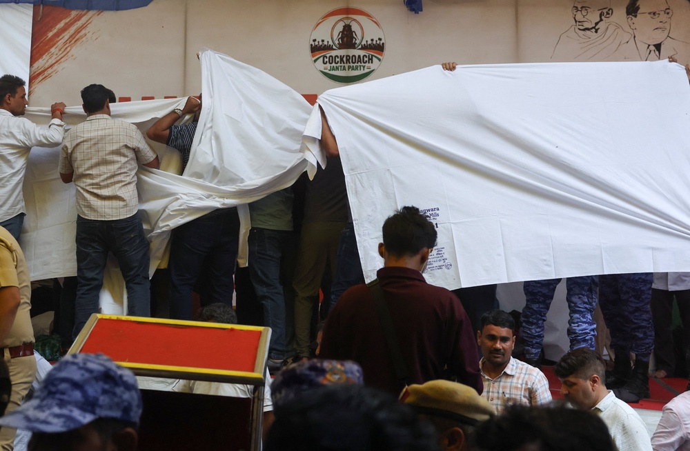 Authorities cover the stage with cloth as they prepare to take Sonam Wangchuk, an Indian education reformer who has been on hunger strike, to the hospital (Reuters)