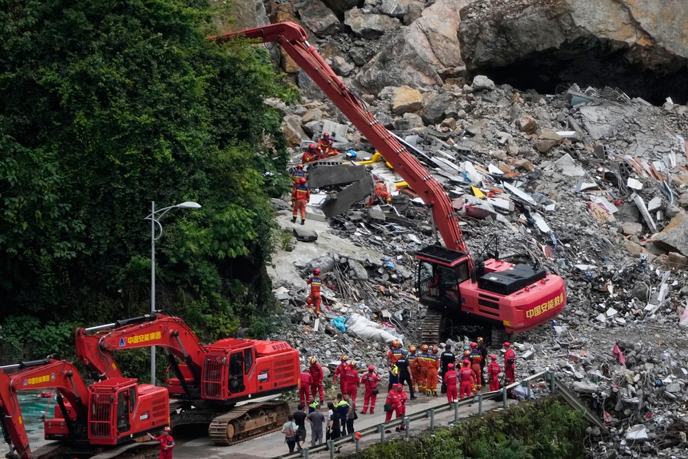 More than 1,100 people have since been relocated from the surrounding area as continuing rain and unstable ground complicated rescue efforts (AP)