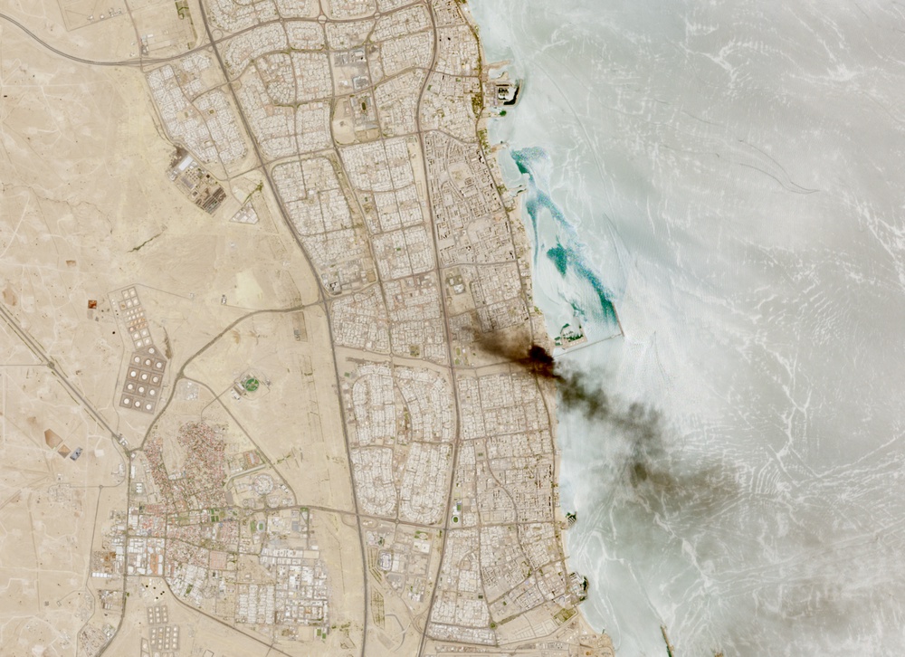 A satellite image shows smoke billowing near an oil facility in Ahmadi Governorate, Kuwait, July 18, 2026. (Reuters)