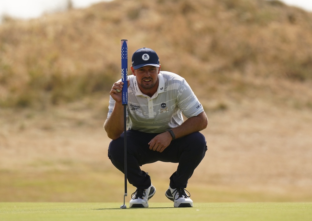 Bryson DeChambeau sizes up a putt on the third green (Jacob King/PA). (PA Wire)