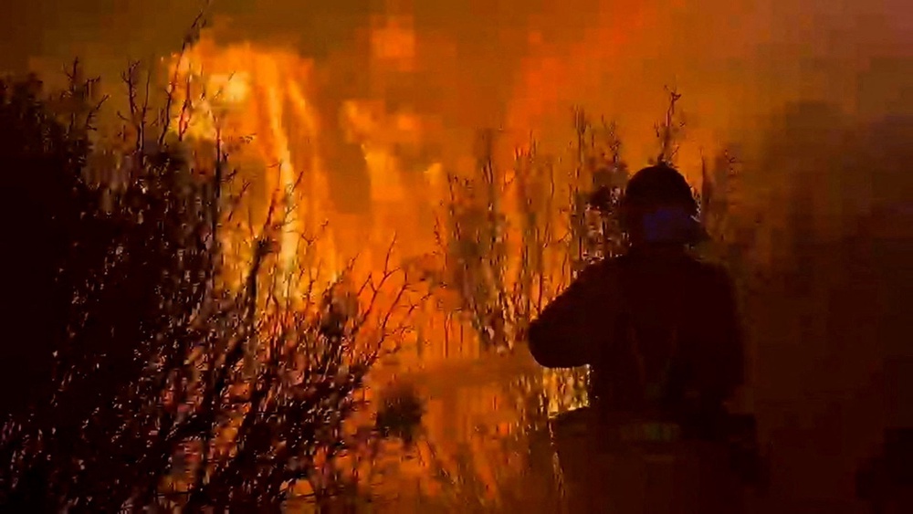 A firefighter works at a site, following a wildfire in the municipality of Ores, northern Aragon region (Reuters)
