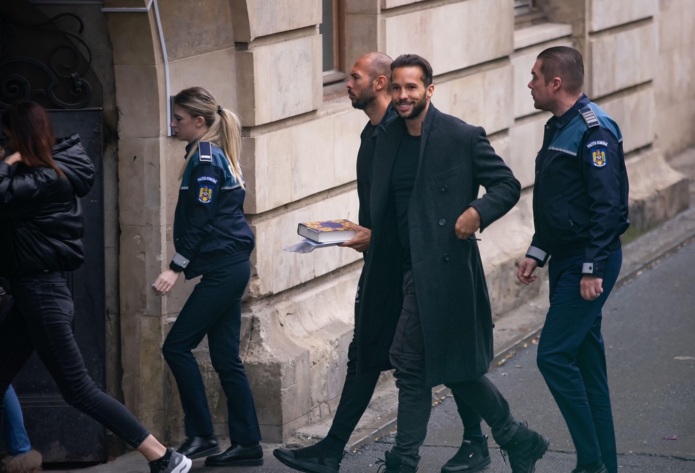 Andrew Tate and his brother Tristan arrive in handcuffs at the Bucharest Court of Appeal (Alamy/PA)