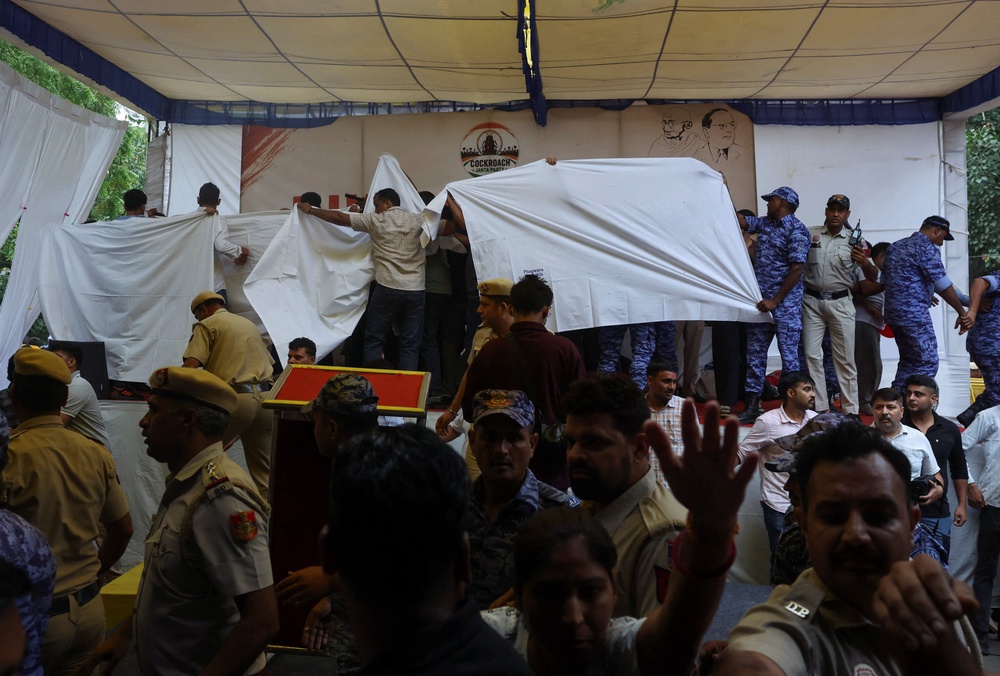 Authorities cover the stage with plain cloths as they prepare to take Sonam Wangchuk to the hospital during a sit-in protest called by Cockroach Janta Party (Reuters)