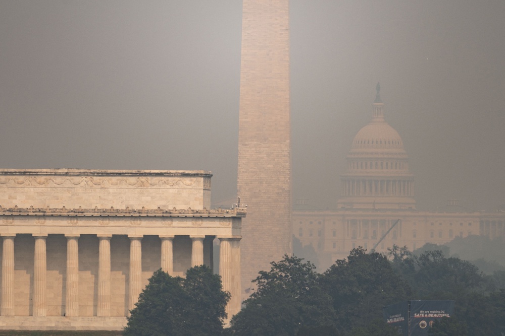 The US Capitol, Washington Monument and Lincoln Memorial are seen through haze caused by wildfire smoke from Canada from the Netherlands Carillon in Arlington, Virginia on July 17, 2026 (AFP via Getty Images)