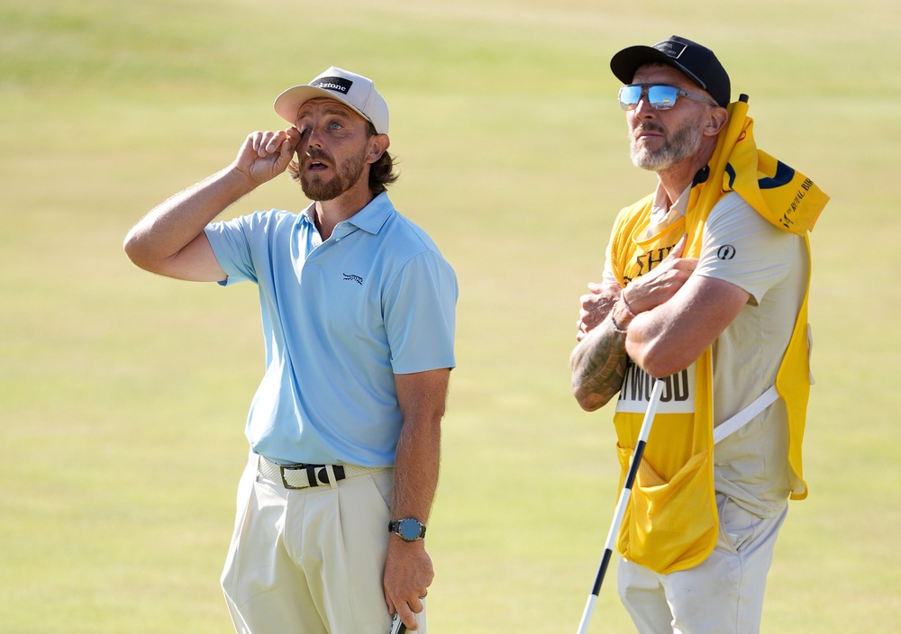 Tommy Fleetwood of England and caddie Ian Finnis on the 18th green (PA)