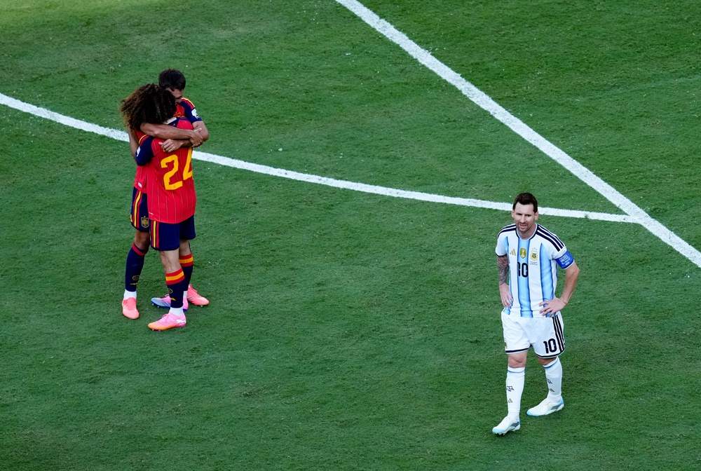 Argentina’s Lionel Messi looks dejected as Spain players celebrate winning (PA)