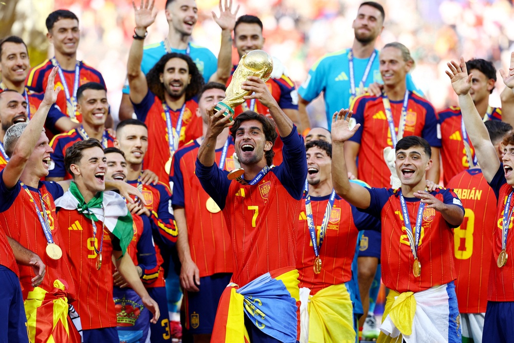 Spain's Ferran Torres lifts the trophy with teammates (Reuters)