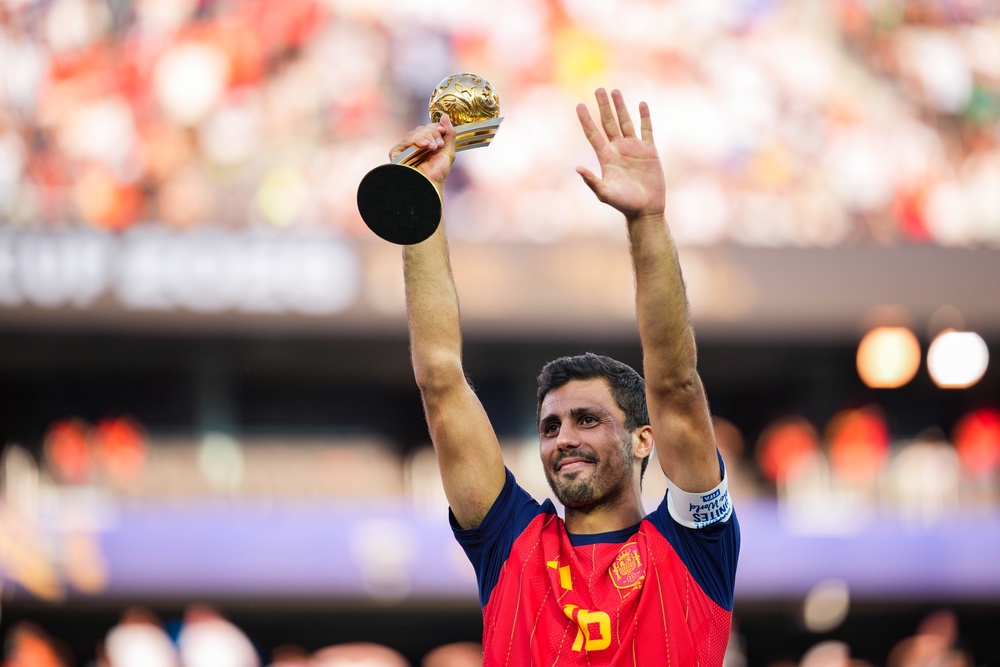Rodri of Spain lifts up the Golden Ball award (Getty)